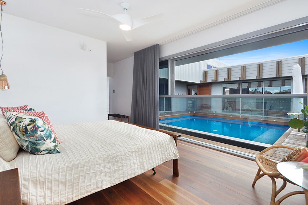 View of the pool from the master bedroom in a luxury home on the Gold Coast